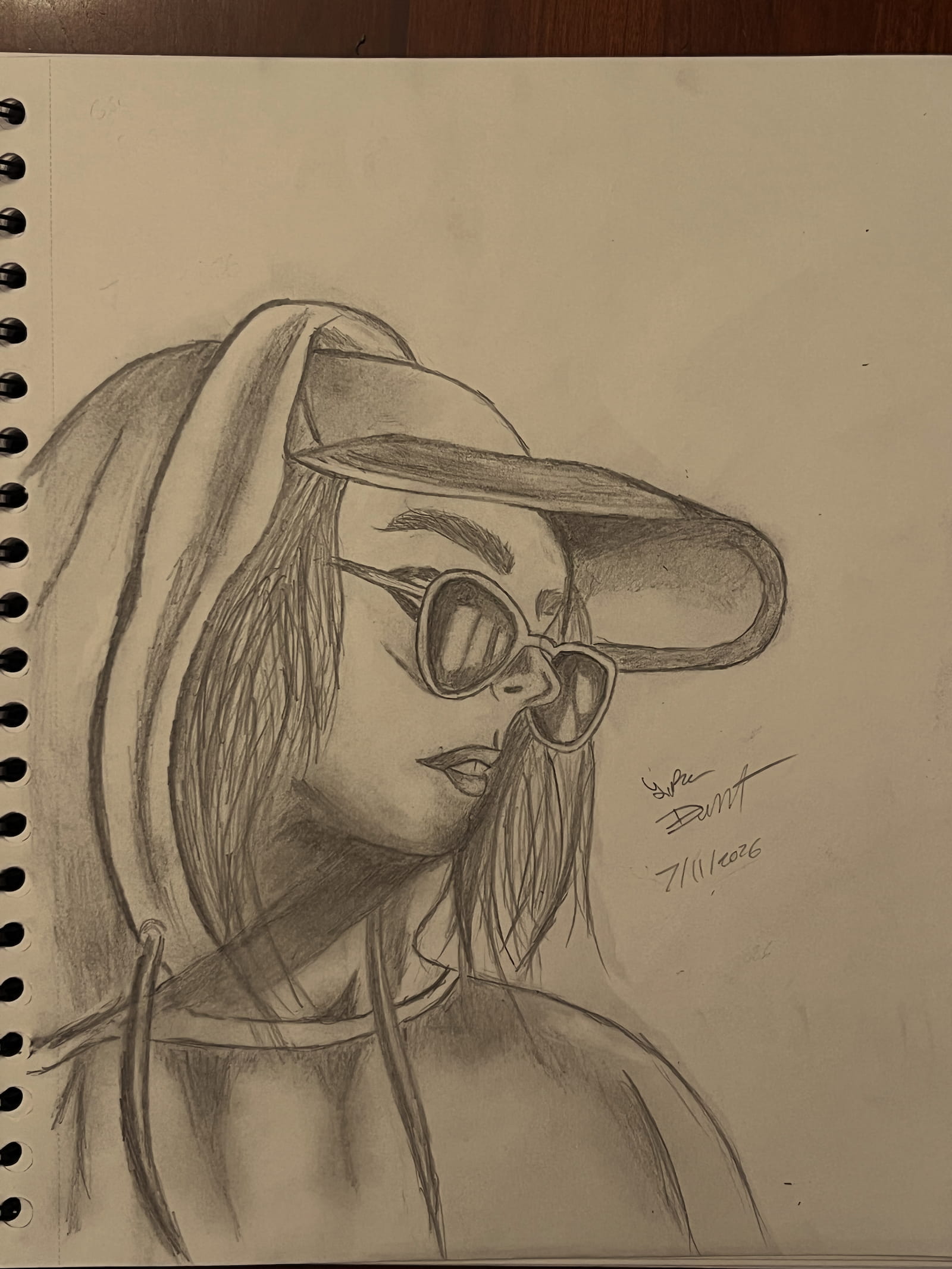 Pencil portrait of a woman in a cap and sunglasses